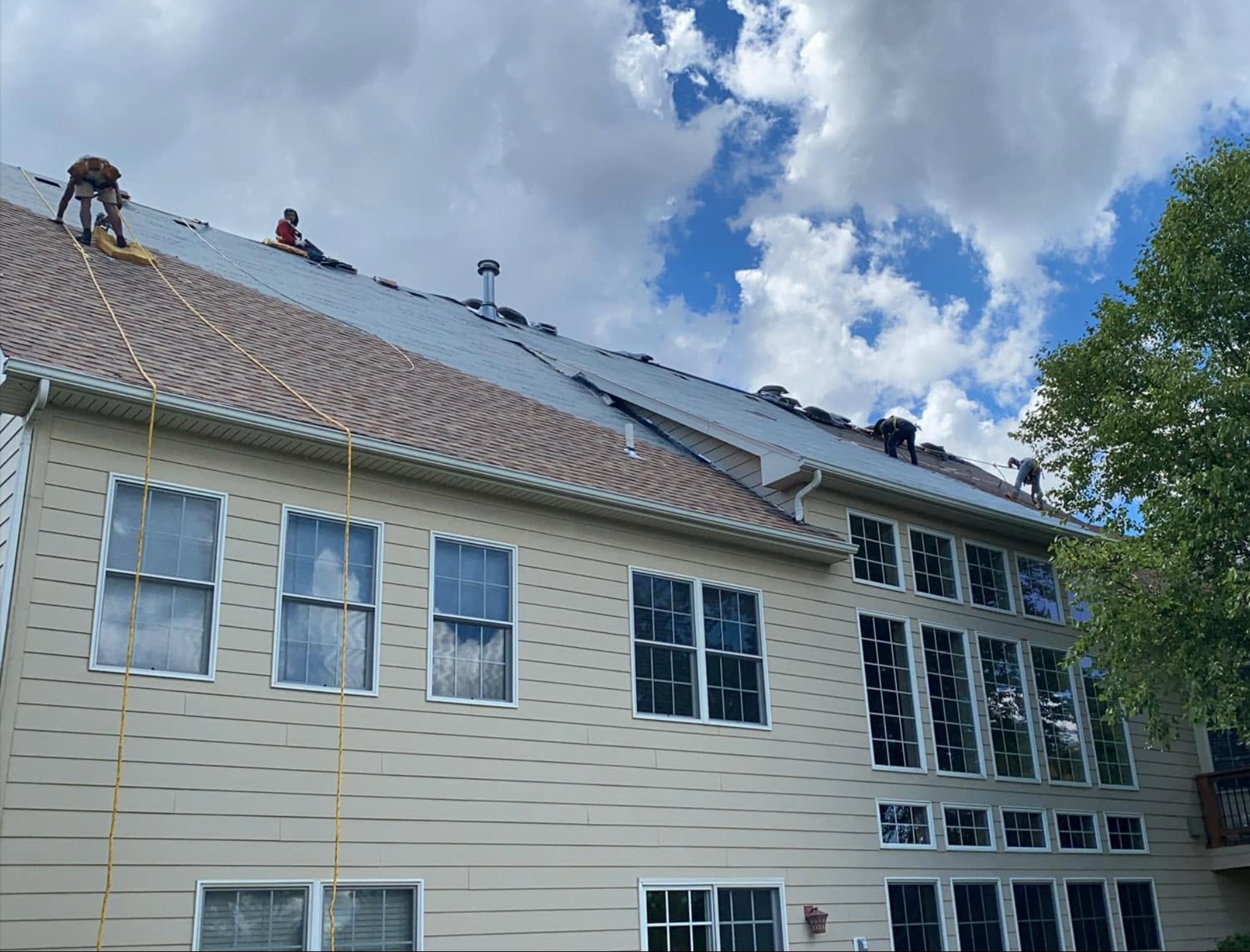 Ohm Restoration crew working on large residential roof Springfield MO