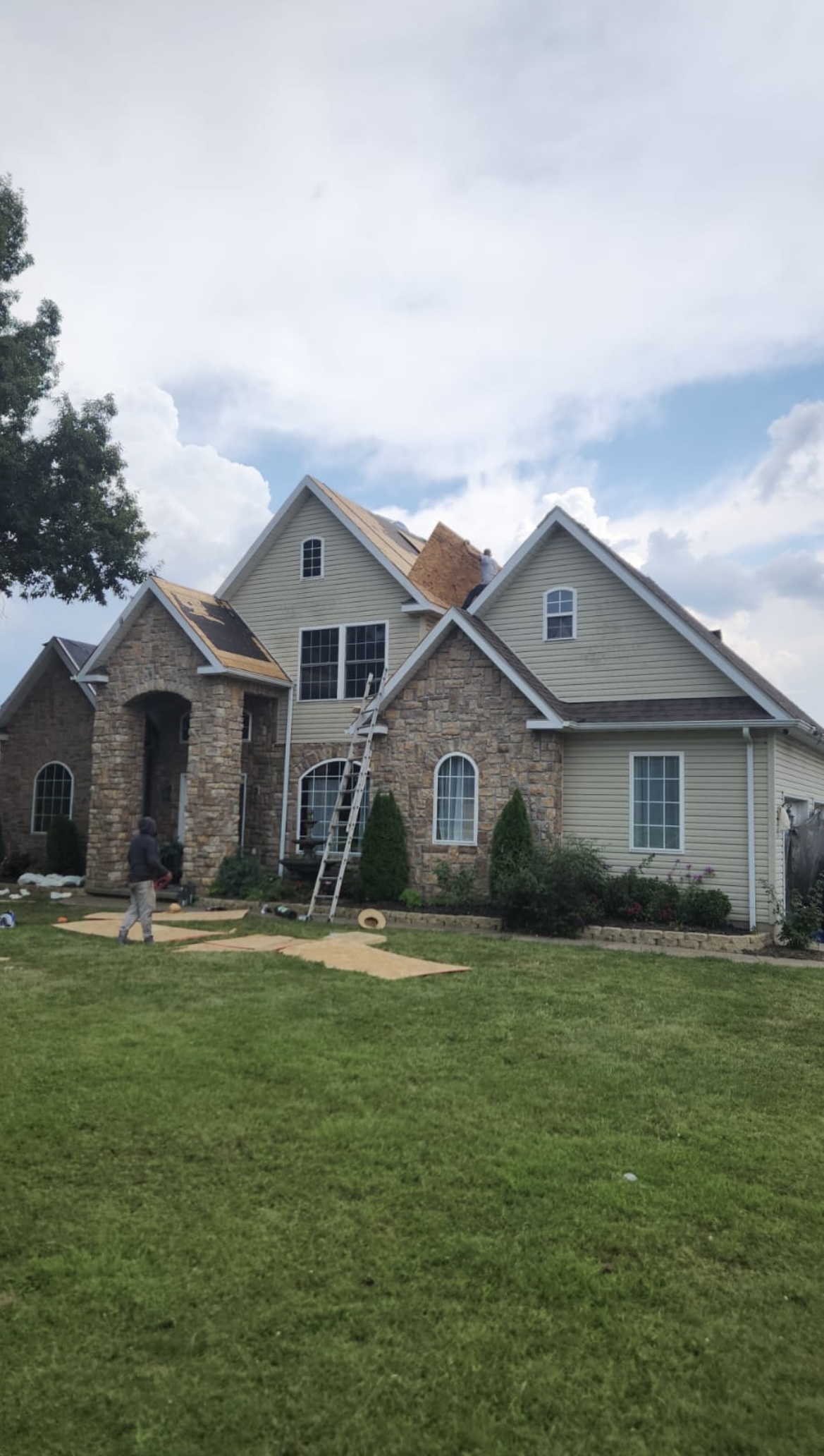 Ohm Restoration crew replacing roof on two-story home Springfield MO